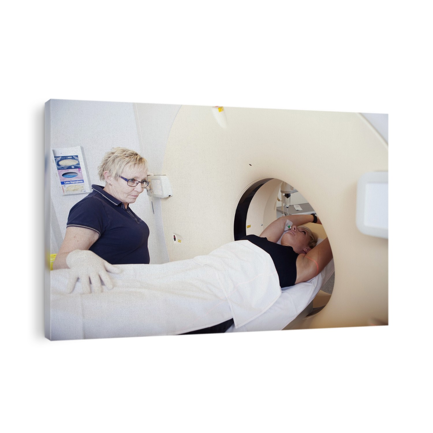 A patient positioned for a CT scan. Also known as CAT (computed axial tomography) scanning, CT (computed tomography) scanning is a diagnostic technique in which X-rays are passed through the body at different angles. A computer then produces cross-sectional images of the tissue being examined. This technique provides clearer and more detailed information about body tissues than X- rays used by themselves.
